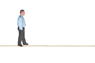 Businessman walking on tightrope clipart