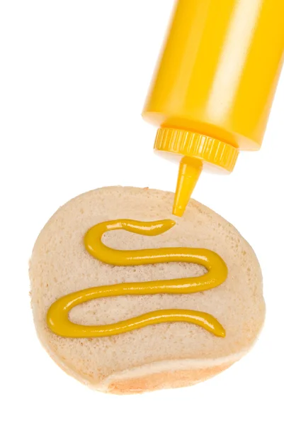 Espalhe de mostarda em pão de hambúrguer — Fotografia de Stock