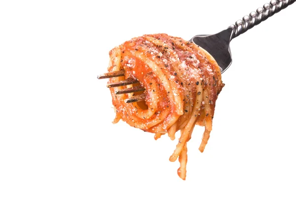 Спагеті обертають навколо виделкою — стокове фото