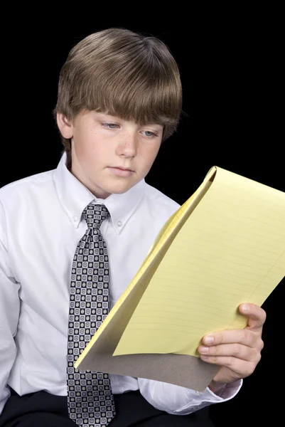 Boy in business dress reading notepad — Stock Photo, Image