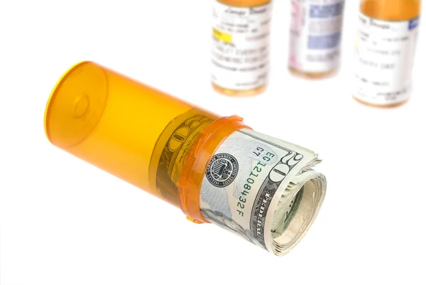 Cash in pill bottle — Stock Photo, Image