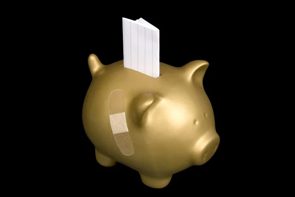 Gold piggy bank with blank paper — Stock Photo, Image