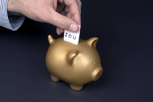 Placing IOU slip into piggy bank — Stock Photo, Image