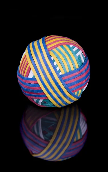 Rubber band ball on black surface — Stock Photo, Image
