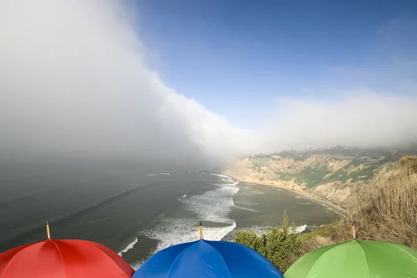 Wetterfront und Regenschirme an der Küste — Stockfoto