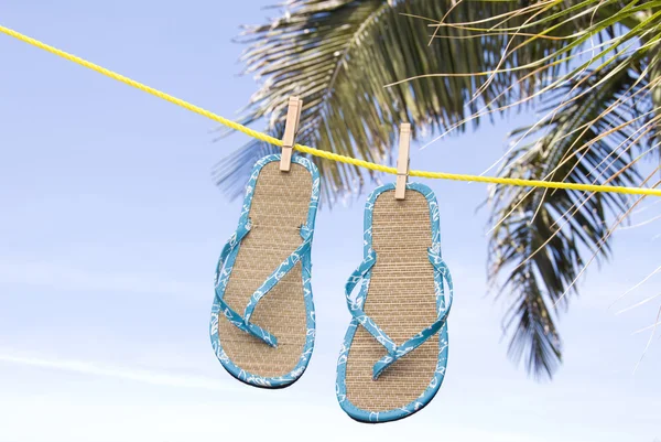 Flip flops hanging on clothesline — Stock Photo, Image