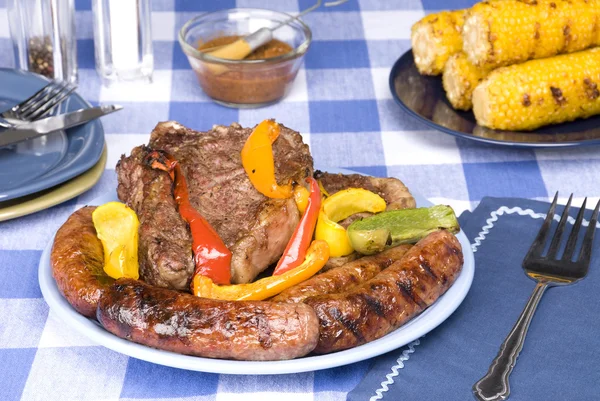 Bratwurst and steak picnic dinner — Stock Photo, Image