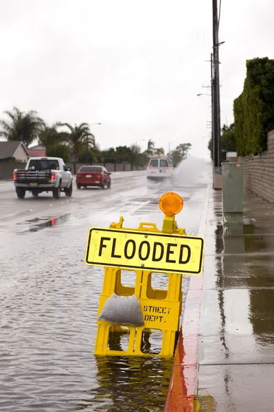 Flooded street and sign — Stock Photo, Image