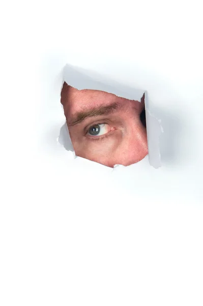 Man peeking through torn paper — Stock Photo, Image