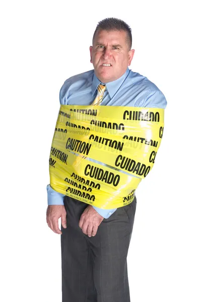Homem de negócios irritado envolto em fita de cautela — Fotografia de Stock