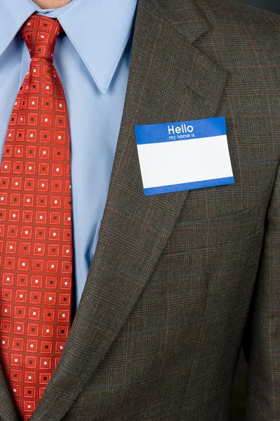 Businessman wearing blank nametag — Stock Photo, Image