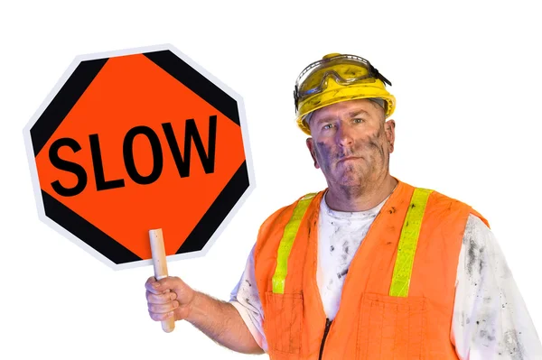 Obrero de la construcción sosteniendo un cartel lento — Foto de Stock