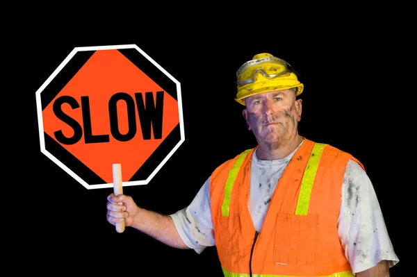 Dirty construction worker holding slow sign — Stock Photo, Image