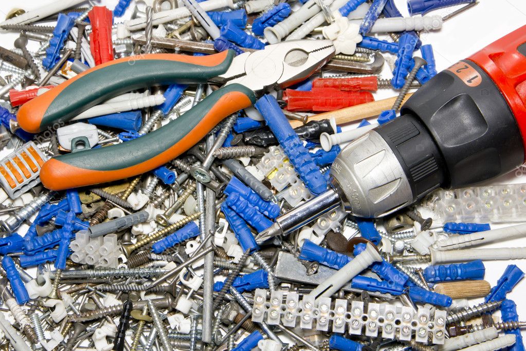 Screwdriver, pleiers, screw, dowels and electric connectors — Stock