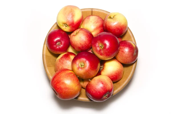 Red apples in a wooden plate — Stock Photo, Image