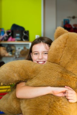 Happy girl with teddy bear clipart