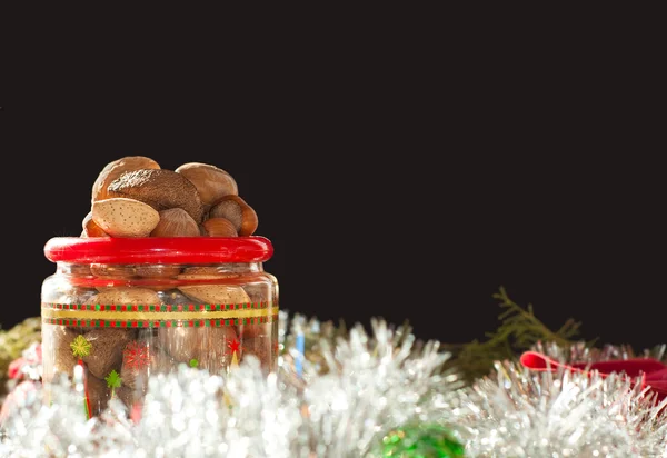 Nuts heaped in a Christmas-themed plastic container — Stock Photo, Image