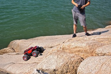 RC toy car on a stone terrain clipart