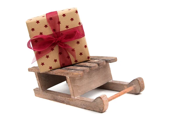 Christmas gift on wooden sledge — Stock Photo, Image