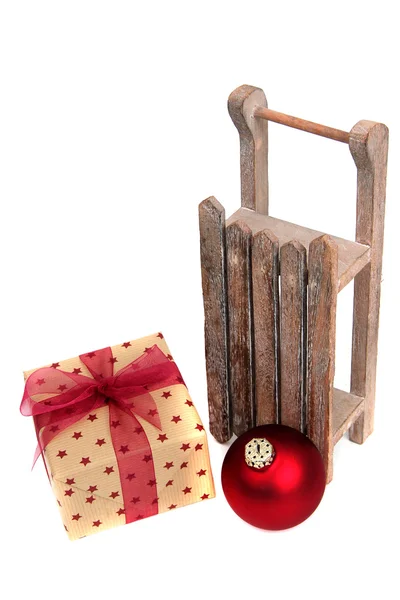 Old wooden sledge with present on white — Stock Photo, Image