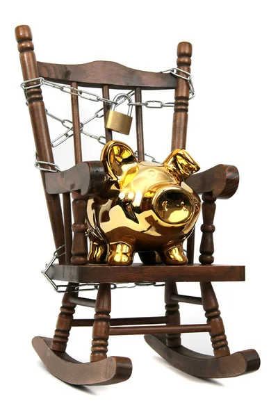 Old wooden rocking chair and piggy bank captured with chain and padlock on — Stock Photo, Image