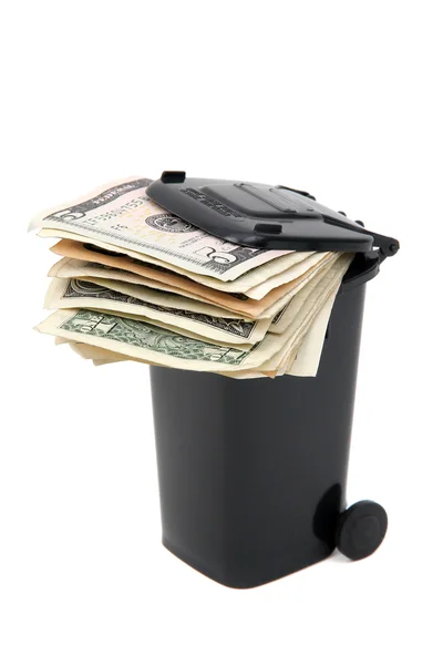 stock image Batch of bank notes in black rubbish bin on white