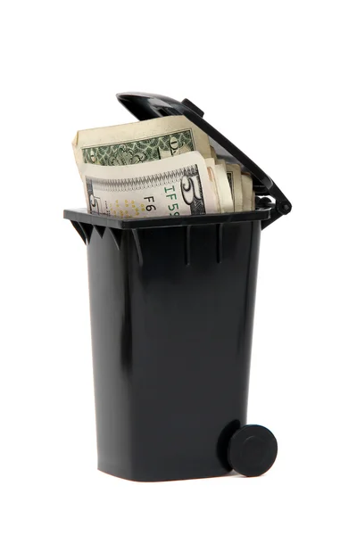 Verschillende bankbiljetten in zwarte vuilnisbak op wit — Stockfoto