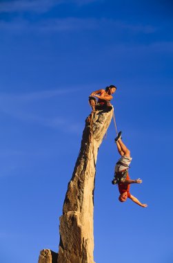 Rock climbers in trouble. clipart