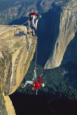 Rock climbers in trouble. clipart