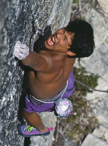 stock image Rock climber clinging to a cliff.
