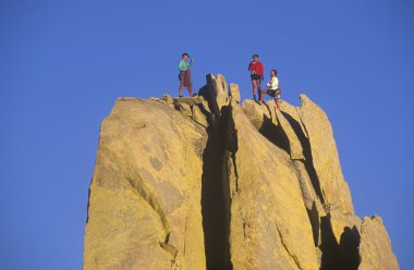 Team of climbers reaching the summit. clipart