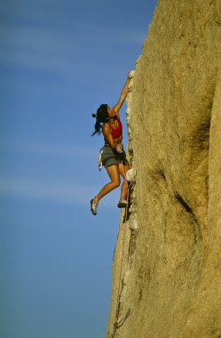 Female rock climber. clipart