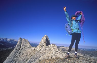 Female climber on the summit. clipart