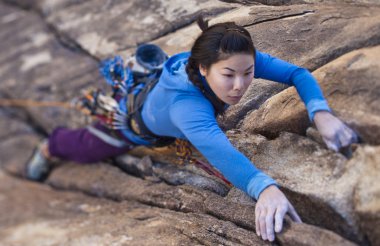 Female rock climber. clipart