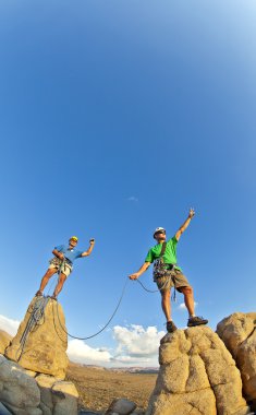 Rock climbing team reaching the summit. clipart