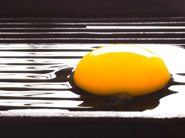 Raw egg on a grill — Stok fotoğraf