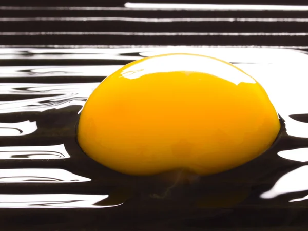 Raw egg on a grill — Stok fotoğraf