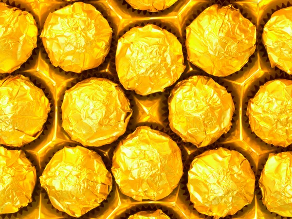 Candy in gold wrappers — Stock Photo, Image