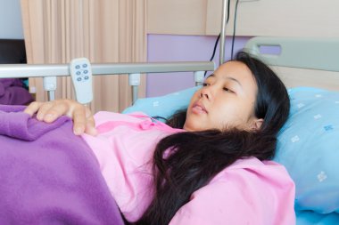 Asian female patient on bed clipart