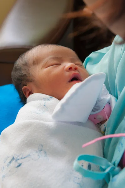 Asiática recém-nascido nos braços da mãe vertical — Fotografia de Stock