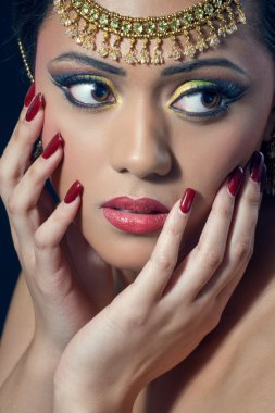 Beautiful indian woman with bridal makeup, closeup shot clipart
