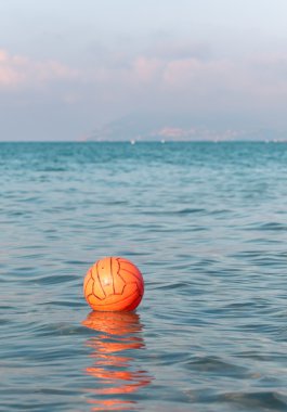 Waterpolo ball floating in the sea waters