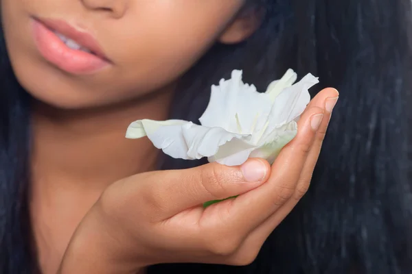 Giovane donna che tiene un fiore tropicale, primo piano colpo — Foto Stock