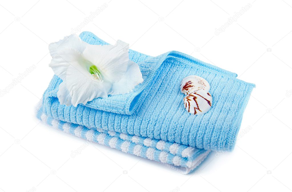 Two cotton towels and a tropical flower, isolated on white