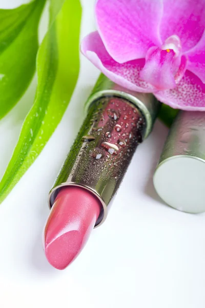 Natural cosmetics concept: lipstick with bamboo and an orchid — Stock Photo, Image