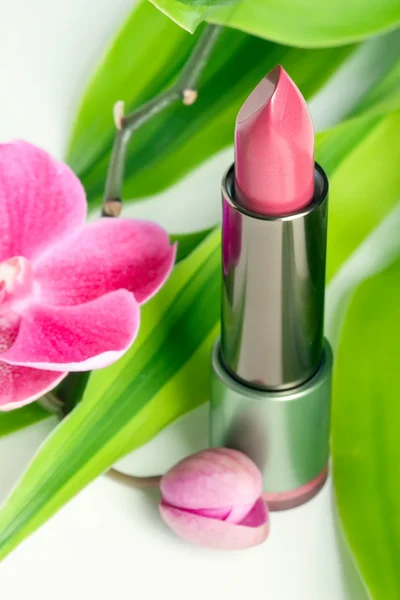 Natural cosmetics concept: lipstick with bamboo and orchid — Stock Photo, Image