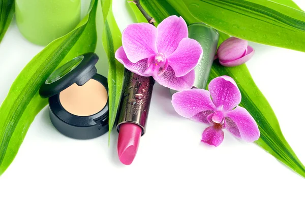 Natural cosmetics concept: concealer and a lipstick with bamboo — Stock Photo, Image