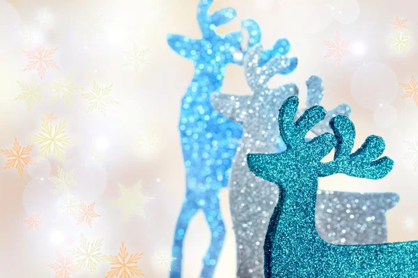 Three reindeers figurines on beautiful winter background — Stock Photo, Image