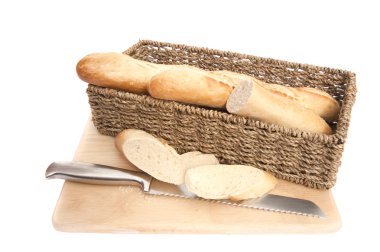 Baguette bread in rustic basket on chopping board isolated on wh clipart