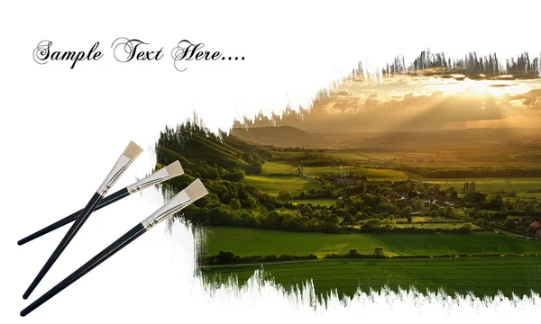 Creative concept image of paint brushes painting landscape on pa — Stock Photo, Image